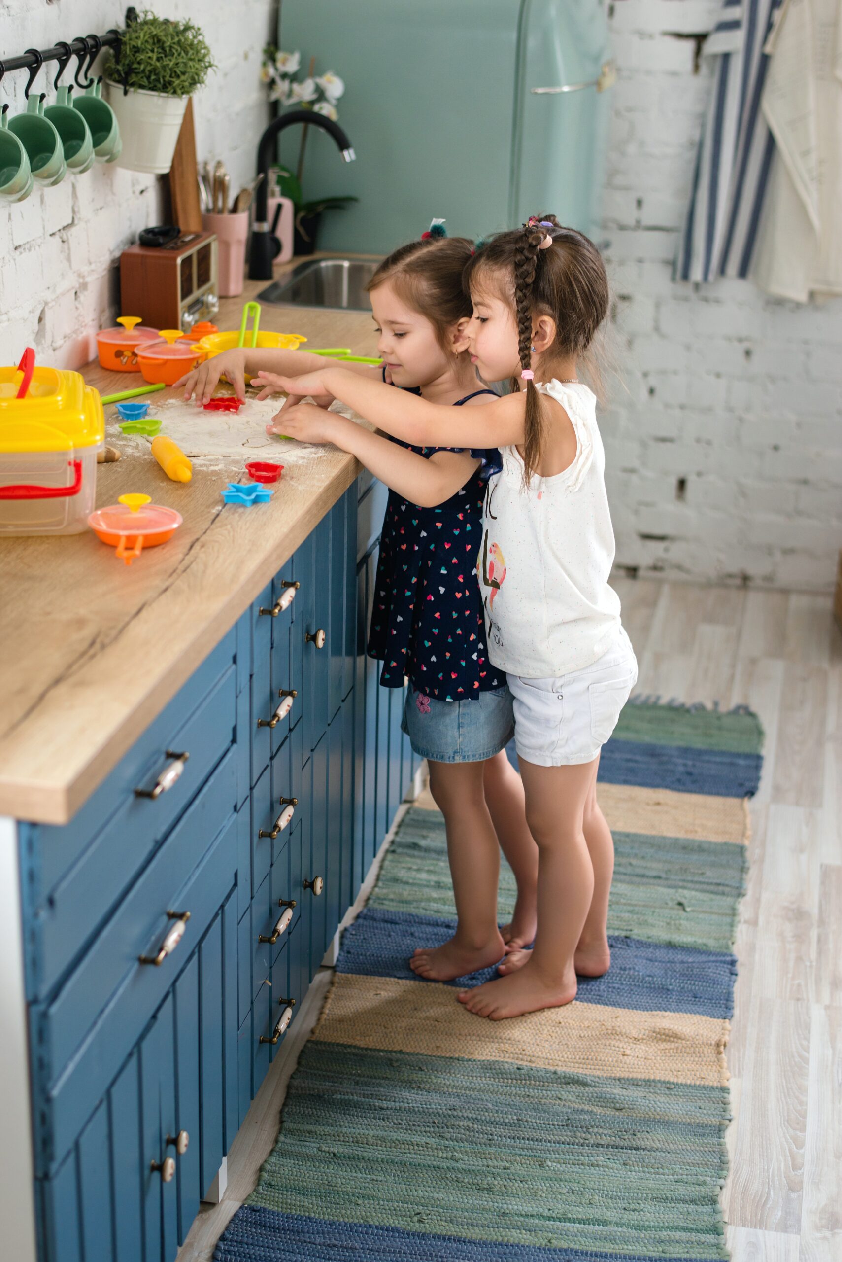 Twin girls playing together with toys