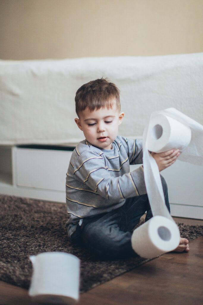 Boy playing with toilet paper