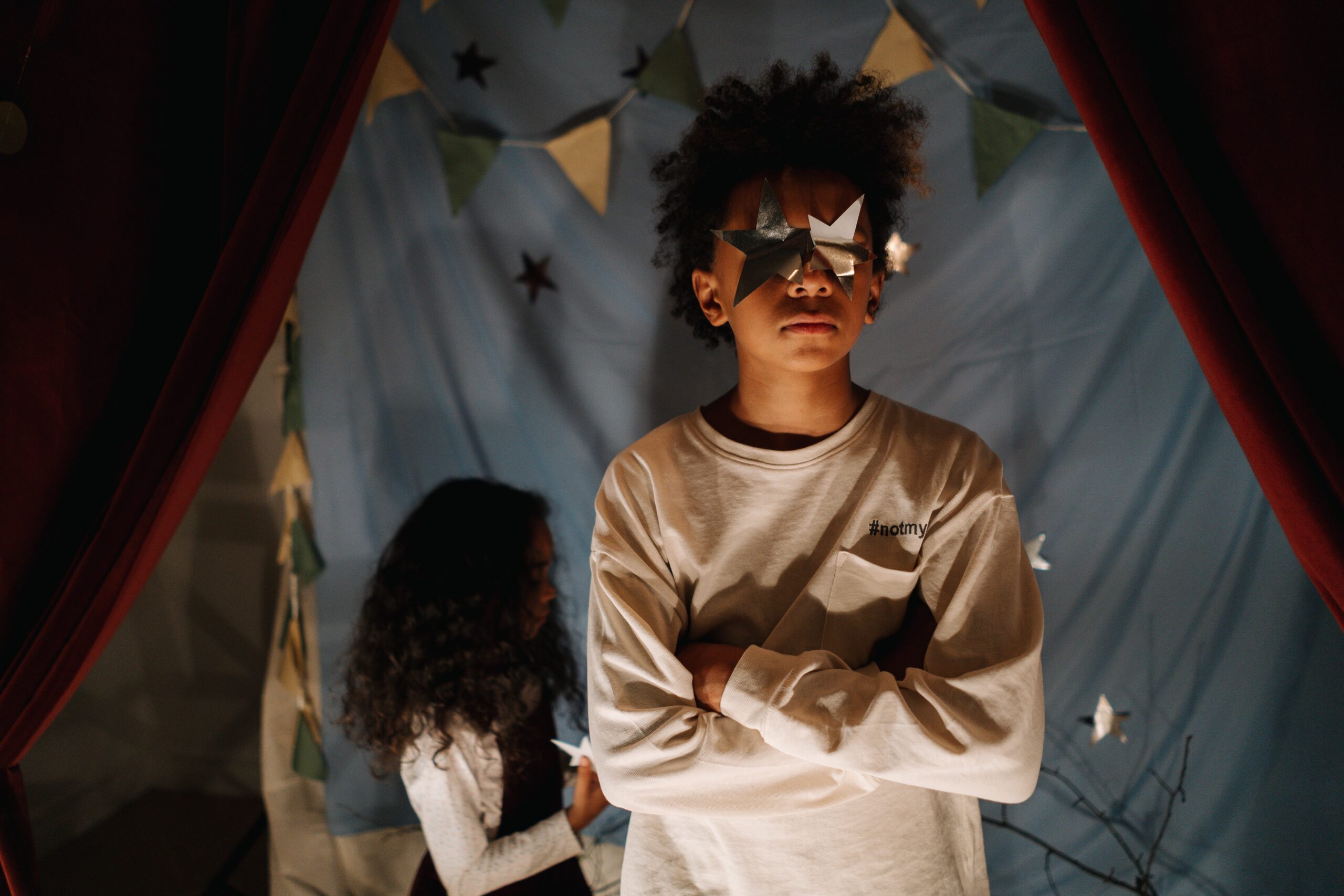 Boy girl twins playing in tent playroom