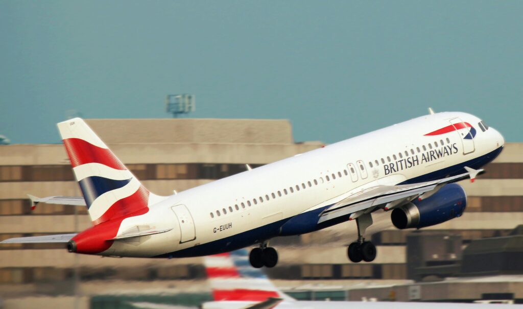 White British Airways airplane taking off runway
